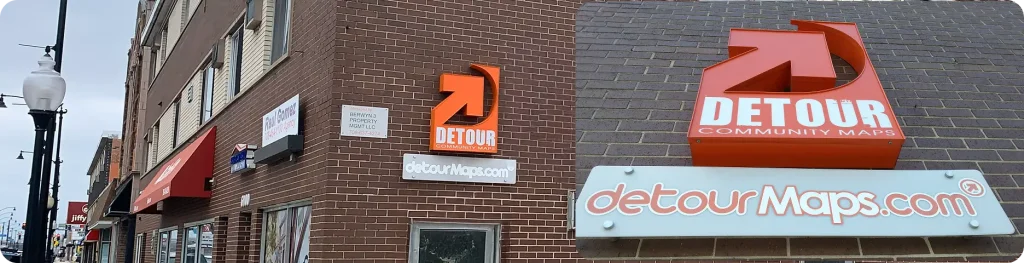 Brick building facade in Berwyn featuring the orange Detour Community Maps sign on 22nd Street.